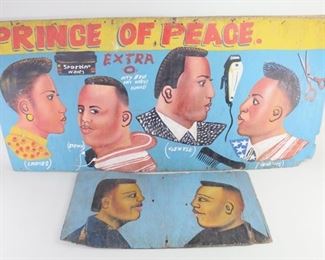 Lot 404: 2 African American Barber Shop,Hair Salon Sign,Folk Art. A pair of beautiful hand painted signs made for a barber shop or hair salon. The larger sign is titled with "the Prince of Peace" and shows four different hair cuts for one woman and three men with various descriptions on a blue background. The second one, with no text, depicts two men facing facing one another, also on a blue background. Painted on wood board. 

Dimensions for the smaller are 13.5 in h x 26.25 in w x 0.25 in d. Dimensions for the larger are 23 in h x 48 in w x 0.25 in d. Condition is good to very good. Minor wear and paint loss. Some cracks and worn edges. Nail holes and discoloration. Please call or email for a detailed condition report.
