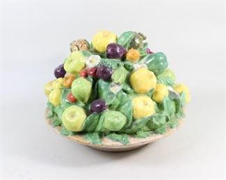 Lot 428: Ceramic Fruit Bowl Trompe L'Oeil Topiary Centerpiece. Pears, apples, figs, oranges, persimmon, cherries, and other fruits fill this lush centerpiece, as well as a small snail lurking among the greenery. Heavy and probably solid enough to hold down a tablecloth in a breeze. 

Dimensions are 8.5 in h x 9.25 in w x 9.75 in d. Condition is good, with crazing, some small cracks and chips. Please call or email for a detailed condition report.