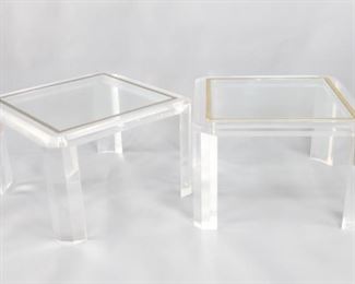 Lot 460: Pair of Modern Lucite Plexi & Gold Side Coffee Tables. Pair of side or coffee tables in clear acrylic plexiglass or lucite. Faceted legs and beveled edge table top with a gold tone metal inlay. The inlay removable and has a "S" stamped into it. 

Dimensions are 18 in h x 27.25 in w x 27.25 in d. Condition is good. Please call or email for a detailed condition report.
