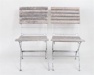 Lot 470:Pair of Wooden Outdoor Garden Patio Cafe Folding Chairs. A pair of classic outdoor folding chair with wood slat seats and back and silver painted metal frame. Great for on a porch, patio or garden.

Dimensions are 32 in h x 19 in seat h x 17.5 in w x 19 in d. Condition is good. Overall surface wear. Please call or email for a detailed condition report.