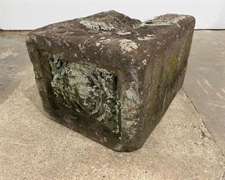 Lot 473: Down Spout Splash Block w/ Face, Architectural Element. This unusual conglomerate stone piece is a splash block for a downspout, used to direct water away from both the home and soil. On this item, there is a carved face protruding from the splash block. There is a divot on the side for catching the stream of water. A unique and useful item for your home.

Dimensions are 10 in h x 12 in w x 16 in d. Condition is fair. There is a good amount of wear, including worn edges, from use and exposure. There is moss and lichen. Please call or email for a detailed condition report.