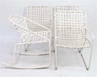Lot 477: Set of 4 Brown Jordan Aluminum Garden Patio Chairs. A set of vintage lawn furniture, three lounge chairs and one rocking chair, in white painted metal and woven vinyl. Wide seats and backs for extra  comfort. Another set of similar lawn furniture is also featured in this auction.

Dimensions for chairs are 31 in h x 15.25 in seat h x 21 in w x 26 in d. Dimensions for rocker are 29.75 in h x 17 seat h x 22 in w x 29 in d. Condition is good. Please call or email for a detailed condition report.