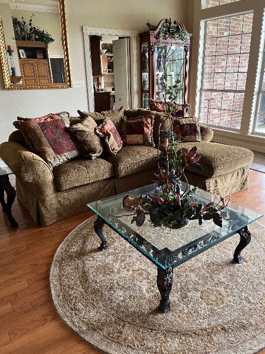 Gold couch, rug, coffee table and decor