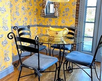 SOLD $400; Glass and wrought iron table and four chairs with blue cushions and scrolls; table is 42” round x 29” high; chairs 17”w x 24”d x 36”h
