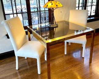 $1800;From the "Contemporain" range solid Brass with characteristic with smoked glass top extension table (has slight wear on one brass edge);  This is the ultimate vintage modern extension table! closed measurement: 42”w x 40”d x 30”h; open: 52”w x 40”d x 30”h. 