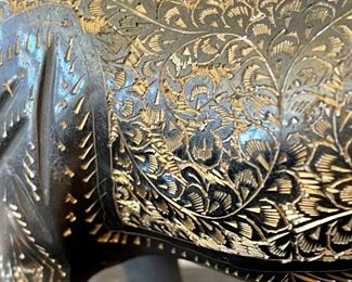 close up of etchings on brass horse