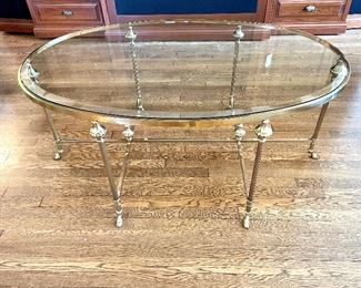 $1200; Hollywood Regency French Hoof Feet Brass Oval with Beveled Glass Top in excellent condition, Large Scale, with height perfect for entertaining, simple yet elegant in design,                                    
Measures: 50”w x 32”d x 22”h