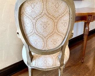 close up of golden beige and ivory dining chairs with upholstered backs