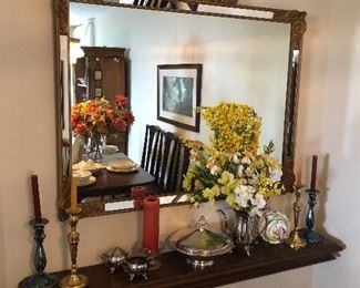 Antique gold framed bezeled mirror, wall shelf and various silver pieces. 