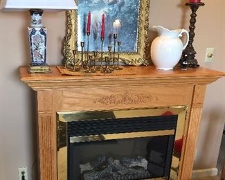 Fireplace- electric, lamp, candles and gold framed art