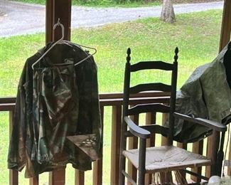 Hunting and fishing clothes and ladder back chair