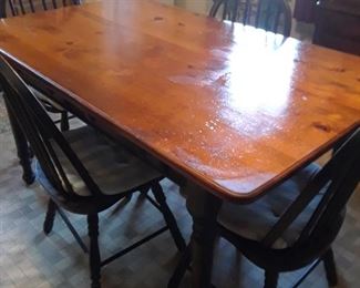 Amish pine table with midnight blue chairs; matches cupboard