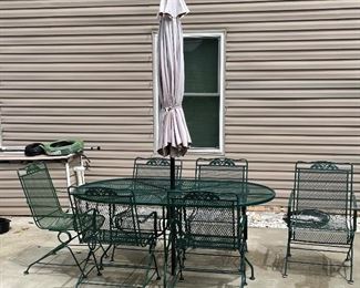 38______$395 		
Green iron dining table with 6 armchairs with umbrella