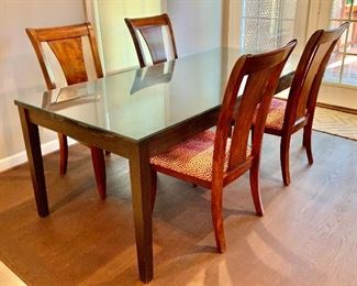 Crate & Barrel extension dining table with integrated leaf storage.  Includes glass top.