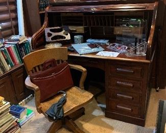 In the study an antique rolltop desk with matching antique oak desk chair, and more books!!