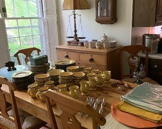 The breakfast room in the kitchen holds a second wonderful antique pine farm table, there is a set of four vintage French chairs with a set of three matching barstools. A wonderful pine chest is up against the wall holding a beautiful antique scale turned into a lamp. There is also a large set of Portuguese pottery for the morning table, Whole Home, French Country Berries en Provence.