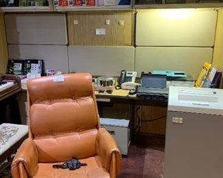 In this area of the office we have printers, phones, adding machines and a large professional Fellows shredder, along with the professional office cubicles. In the front is a vintage Italian office chair.