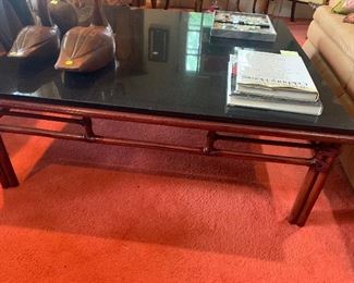 A close up of the base of the McGuire coffee table