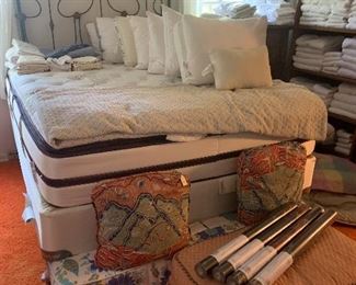 The linen room has both a full bed and a queen bed for sale, the queen is a Beautyrest and was in a guest bedroom hardly ever used. There is an antique French iron headboard in the background extra ottoman and designer pillows with four rolls of Nina Campbell wall paper.
On the bed is a large selection of down pillows, mostly full size. Large vintage swag pendant smoke glass hanging light.