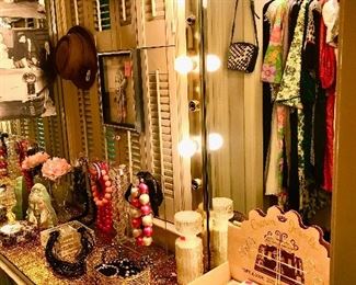 Women's dressing room has lots of colorful baubles, bangles, and beads.