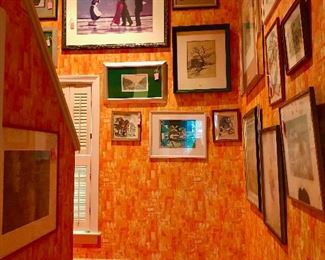 The upstairs hallway features a fine and vast collection of framed art prints.