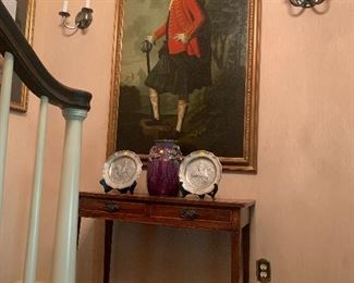 A wonderful Matalin Smith portrait flanked by a pair of silver plated sconces original from the Walnuts. Below is an American hall table. 