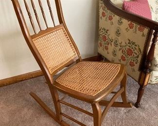 Antique wood rocker with cane seat and back
