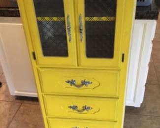 Yellow cabinet with e drawers - top portion opens