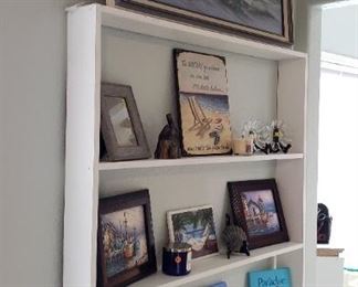 Shelf, trinkets, large painting by R. Taylon