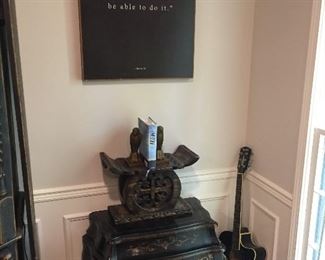 Oriental decorative items along with guitar that was once played by a guy who knew a guy that once had a friend that shook hands with Willie Nelson.