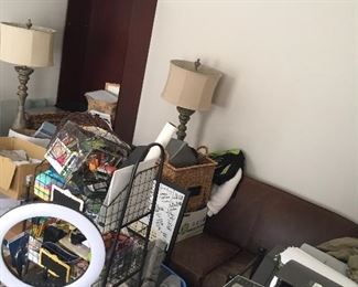 Office supplies accent the super kush leather loveseat and tall floor lamps.