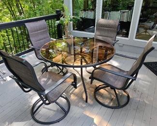 GLASS TOP PATIO TABLE & 4 SWIVELING CHAIRS