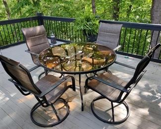GLASS TOP PATIO TABLE & 4 SWIVELING CHAIRS