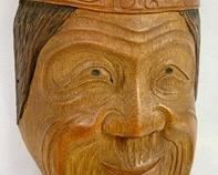Carved Antique Wooden Mask: Smiling, Wrinkled Face, Dark Hair, Headband