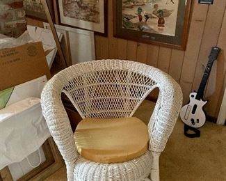 Framed artwork, vintage wicker chair.