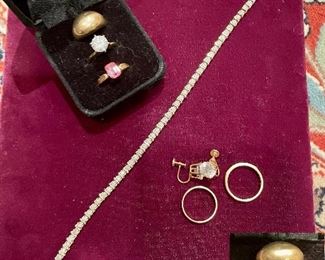 Rings in display box; 10k gold dome ring, 14k gold ring/CZ's, 10k pink gemstone ring.                                          
10k tennis bracelets w diamonds, 10k gold wedding band, 14k gold ring with emeralds & diamonds, 14k gold clip earrings w CZ's