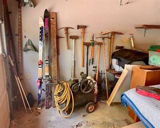 Snow skis, axes, mattocks, old generator.