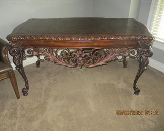 Ornate iron and wood desk with leather top