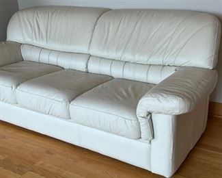 Lovely Leather Ivory Sofa in very good condition. The seating area appears to be leather, while the base is a handmade material. 

Measures 81" x 31".