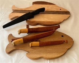 Two Wooden Fish Shaped Cutting Boards & J. Martini Filet Knives and one Rapala Knife. Items are in good/used condition with some wear/use. Please see all photos. 