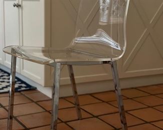 Set of 4 acrylic chairs with metal frames. Each measures 18" W with 17.5" seat height. Some chairs need new seat screws. Photo 1 of 2.