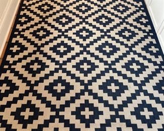 Graphic blue and white indoor/outdoor rug - 2 available. Each measures 7' 7" x 5' 3." Photo 1 of 2.