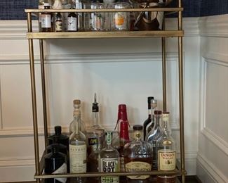 Metal bar cart on casters with brass finish. Measures 24" W x 16" D x 33" H. Photo 1 of 3.