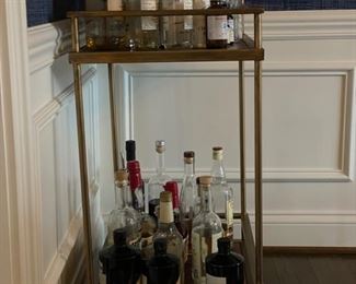 Metal bar cart on casters with brass finish. Measures 24" W x 16" D x 33" H. Photo 2 of 3.