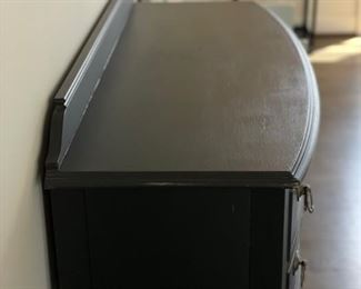 Ebony four-drawer console with decorative pulls and shelf. Measures 46" W x 18" D x 36" H. Photo 3 of 4.