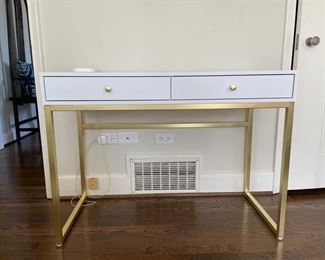 Parsons-style white desk with gold metal frame. Measures 42" W x 19" D x 31" H. Photo 1 of 3.