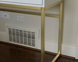 Parsons-style white desk with gold metal frame. Measures 42" W x 19" D x 31" H. Photo 2 of 3.