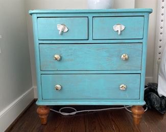 Chest of drawers with distressed aqua finish and elephant head and graphic pulls. Measures 36" W x 19" D x 31" H. Photo 1 of 4.
