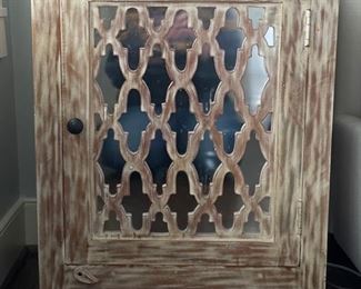 Side table with rustic finish and mirrored lattice front. Measures 22"W x 17" D x 29" H. Photo 1 of 2.