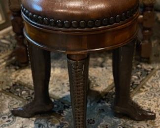 Manhattan Art & Antiques leather footstool with brass and copper lace up shoes for legs.